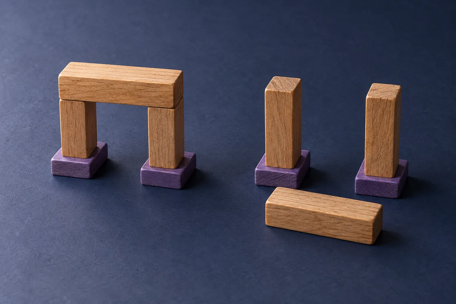 A complete wooden bridge beside matching supports with the connecting block lying separately in front.